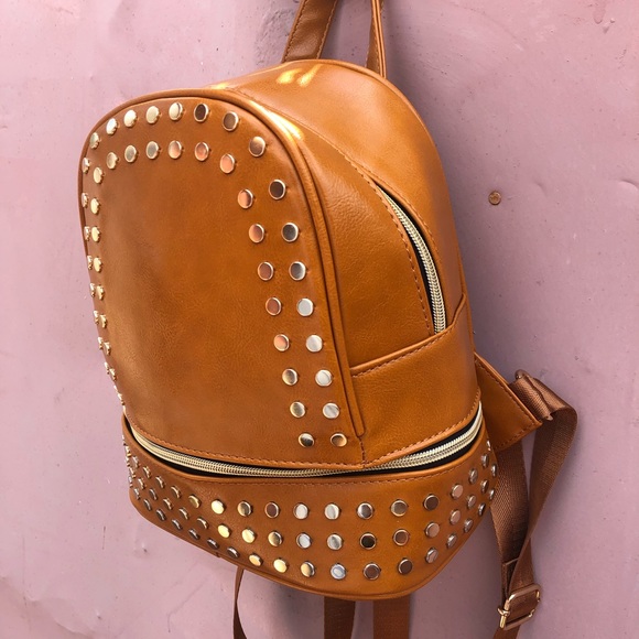 Selling a tan purse with studs surround the purse. - Picture 2 of 4